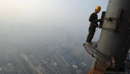 A labourer works on a steel structure at a construction site in Hefei
